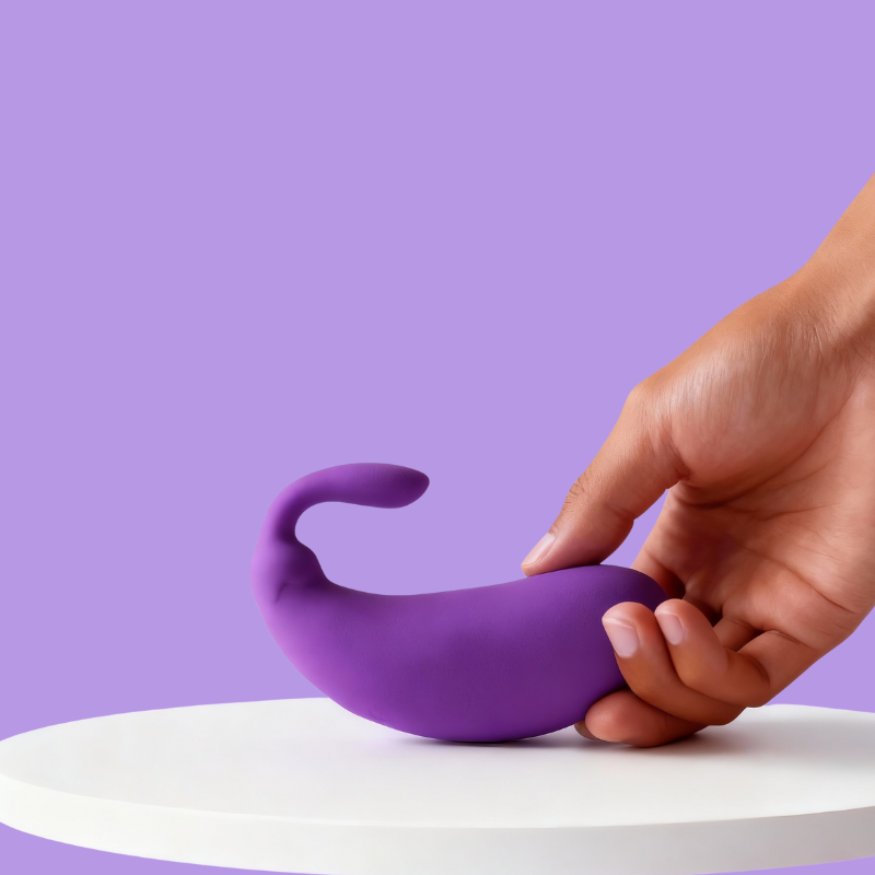 Front view of the playful purple mini eggplant vibrator held comfortably in a hand, showcasing its compact and discreet size for personal use.